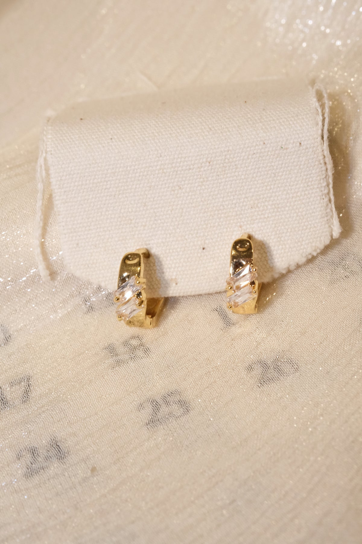 Offset Baguette CZ Huggie Earrings — Gold — edited real product photo
