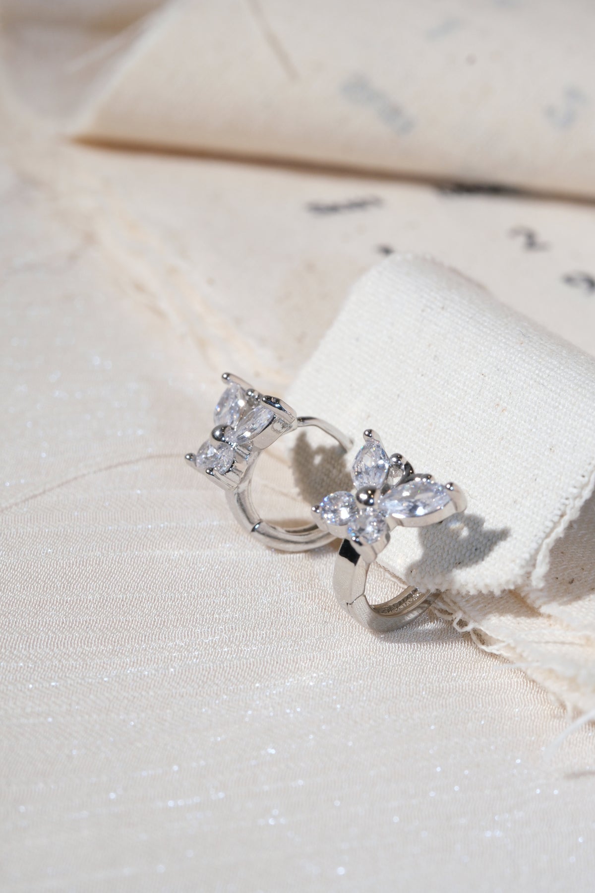 Silver Butterfly CZ Huggie Earrings — edited real product photo