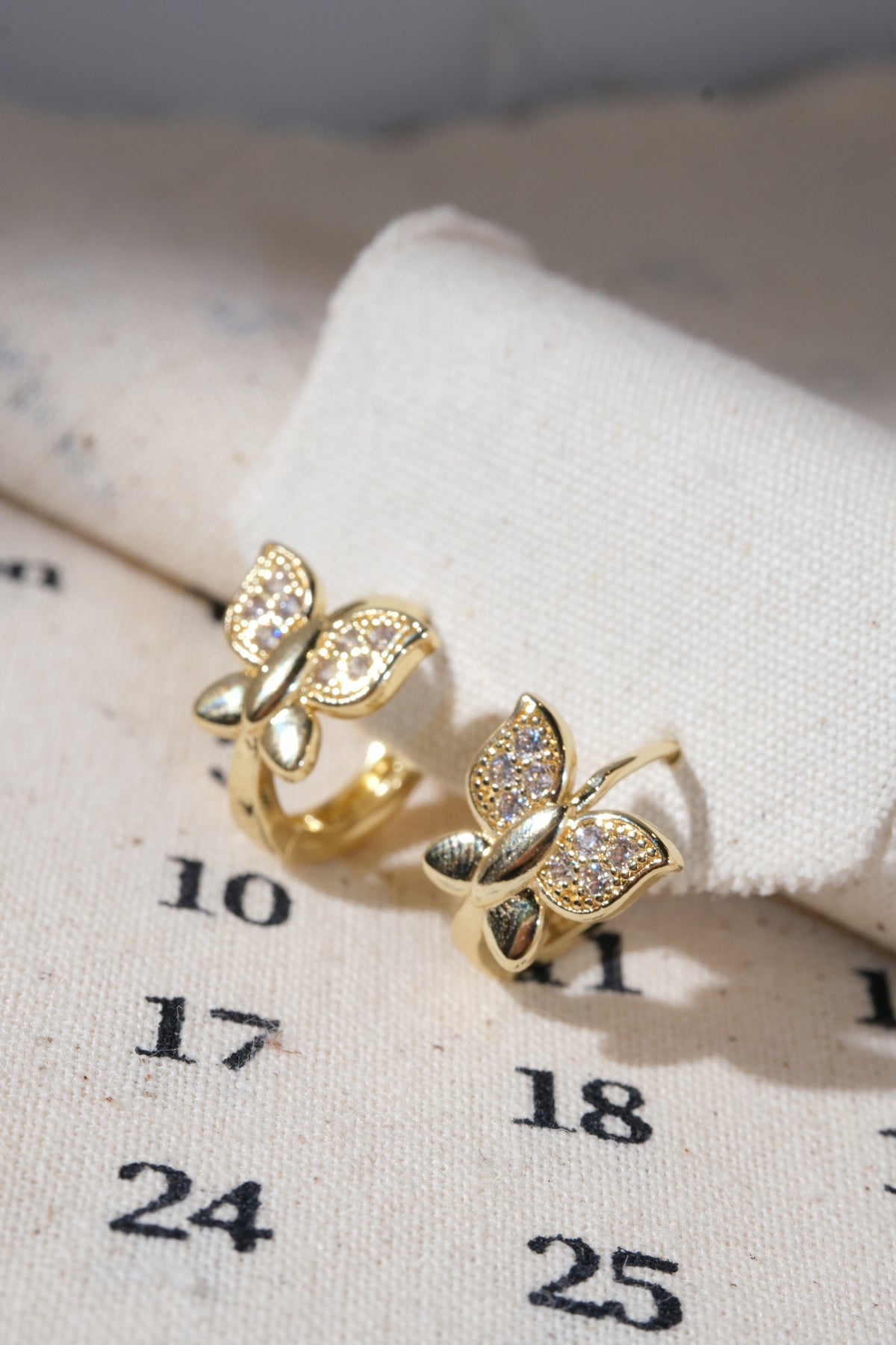 Gold Pave Butterfly Huggie Earrings — edited real product photo