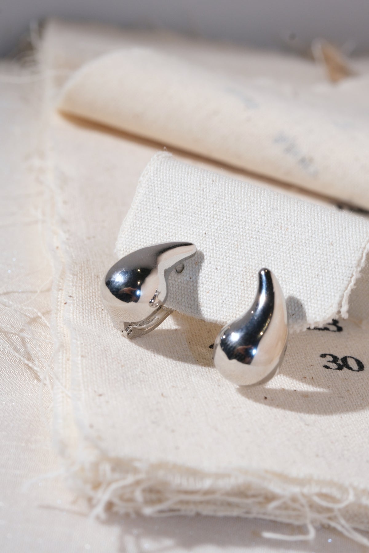 Silver Sculpted Teardrop Earrings — edited real product photo