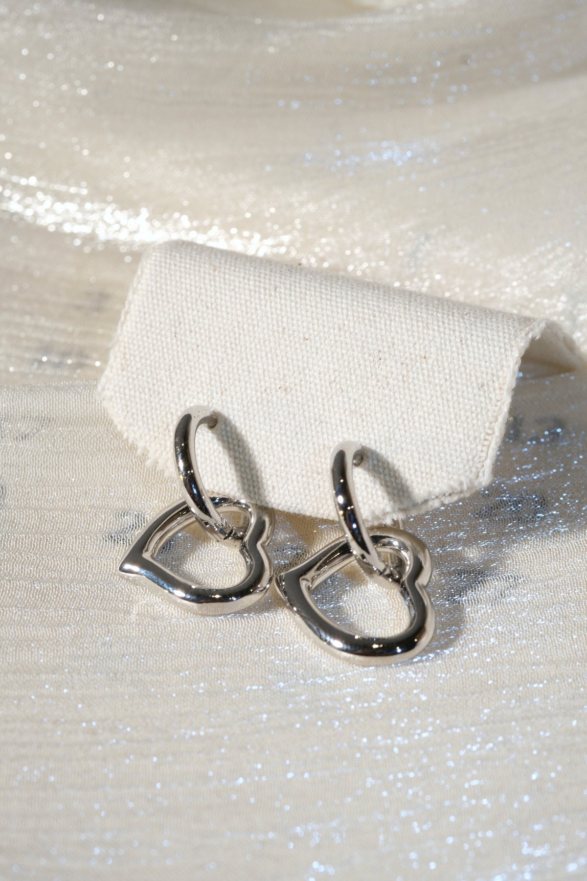 Open Heart Drop Earrings — Silver — edited real product photo