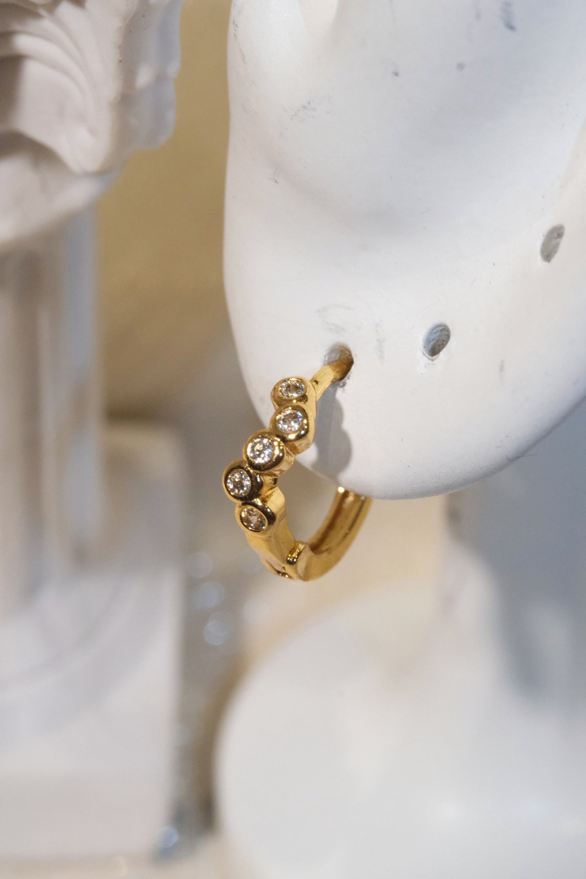 Five-Stone Bezel CZ Huggie Earrings — Gold — edited real product photo