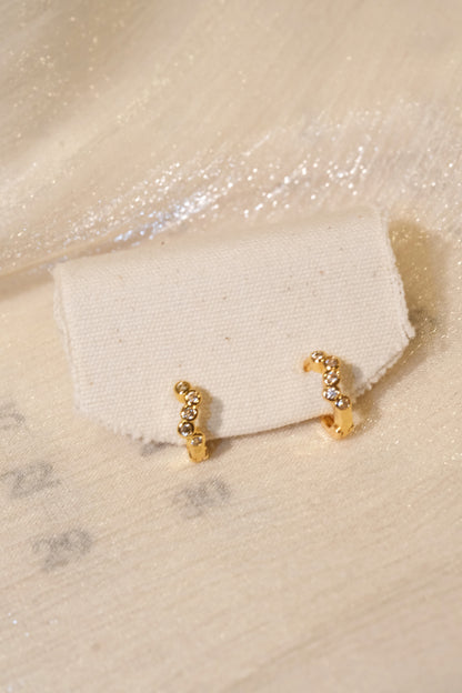 Five-Stone Bezel CZ Huggie Earrings — Gold — edited real product photo