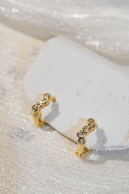 Five-Stone Bezel CZ Huggie Earrings — Gold — edited real product photo