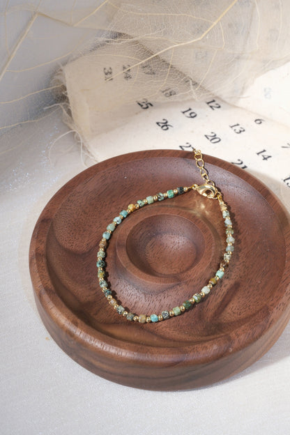 Green Gold Tone Patterned Spacers Bracelet — real product photo