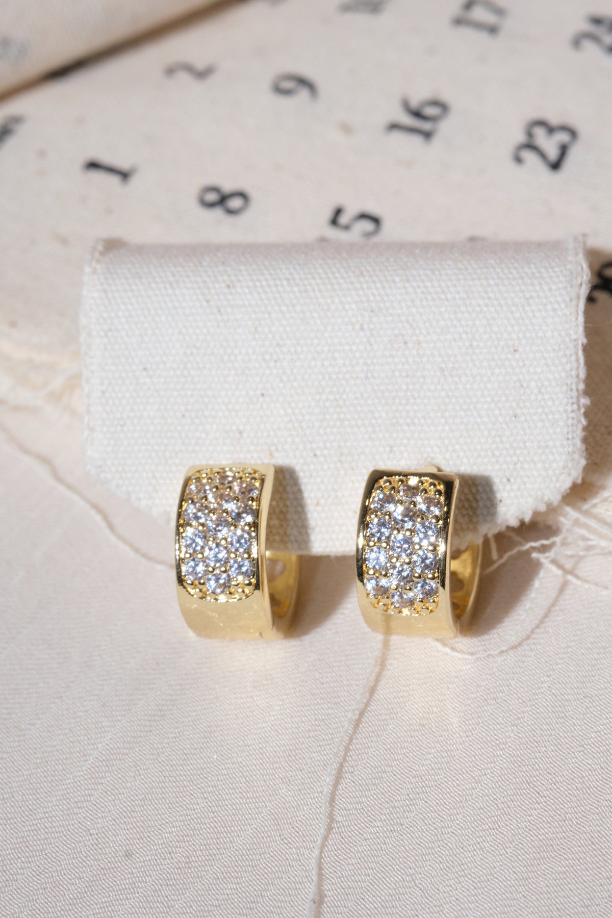 Gold Wide Pave Huggie Earrings — edited real product photo