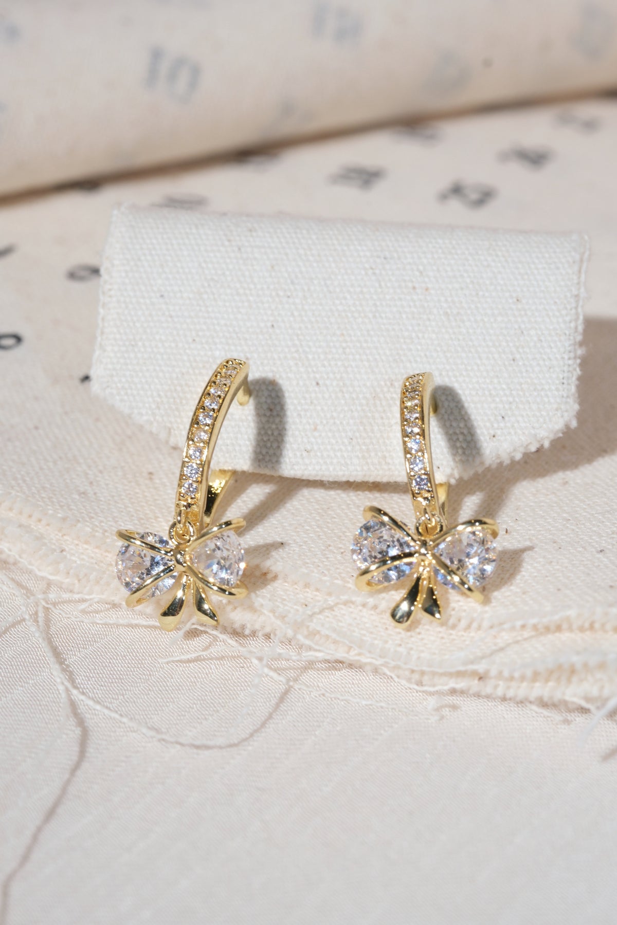 Gold Bow Dangle Hoop Earrings — edited real product photo