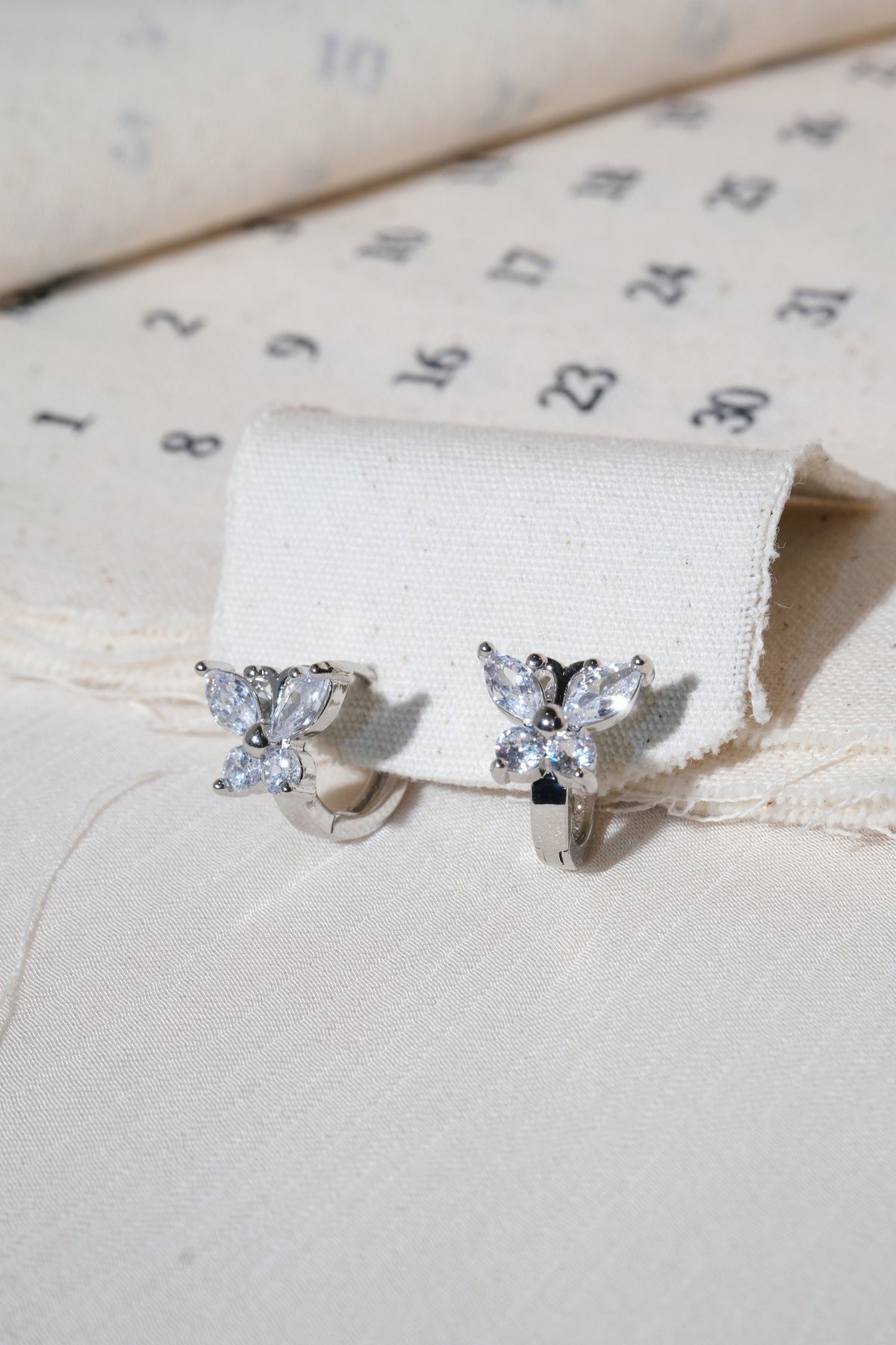 Silver Butterfly CZ Huggie Earrings — edited real product photo