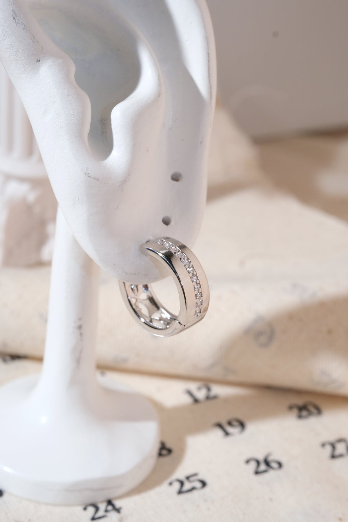 Silver Center-Line CZ Huggie Earrings — edited real product photo