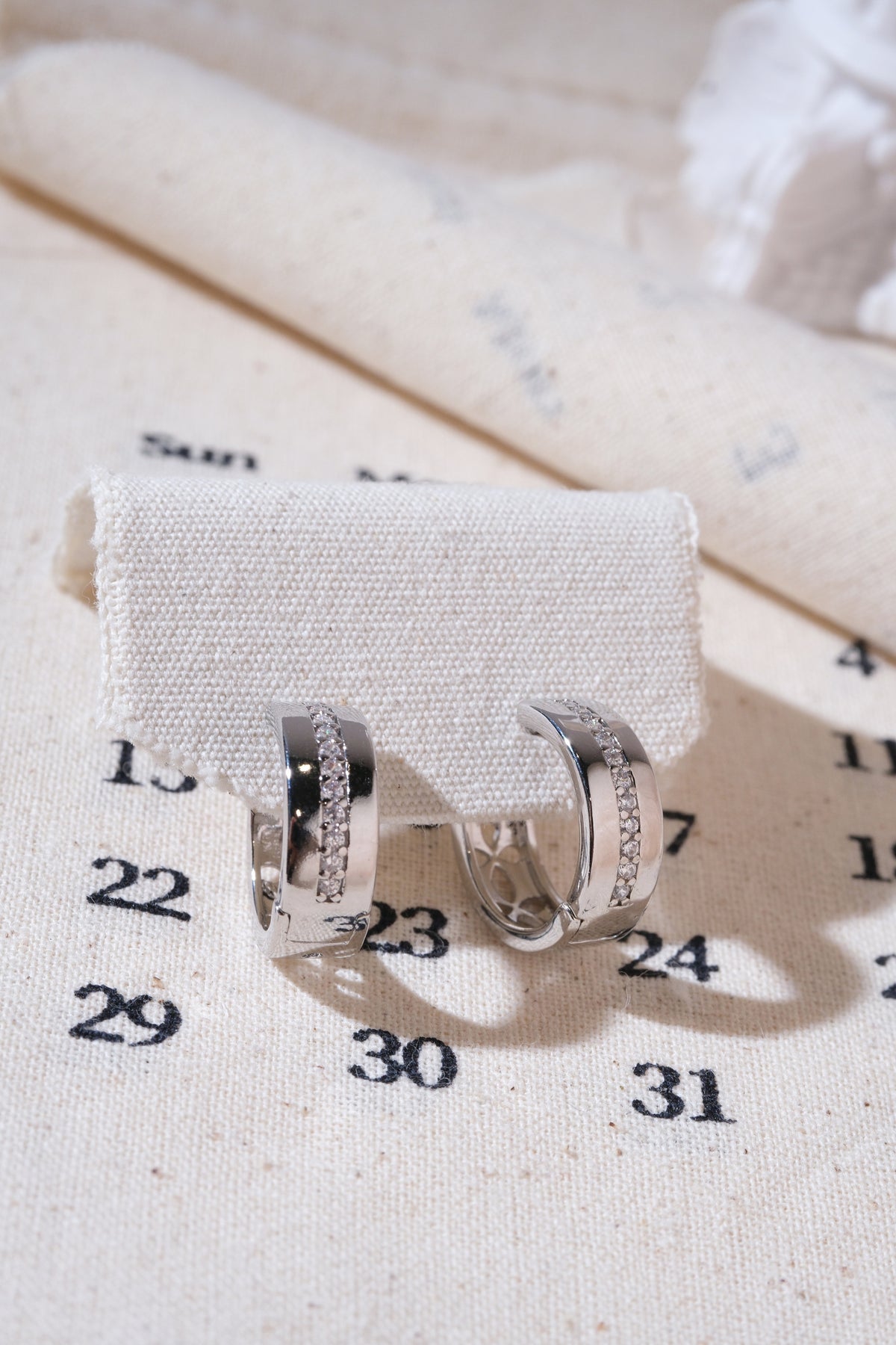 Silver Center-Line CZ Huggie Earrings — edited real product photo
