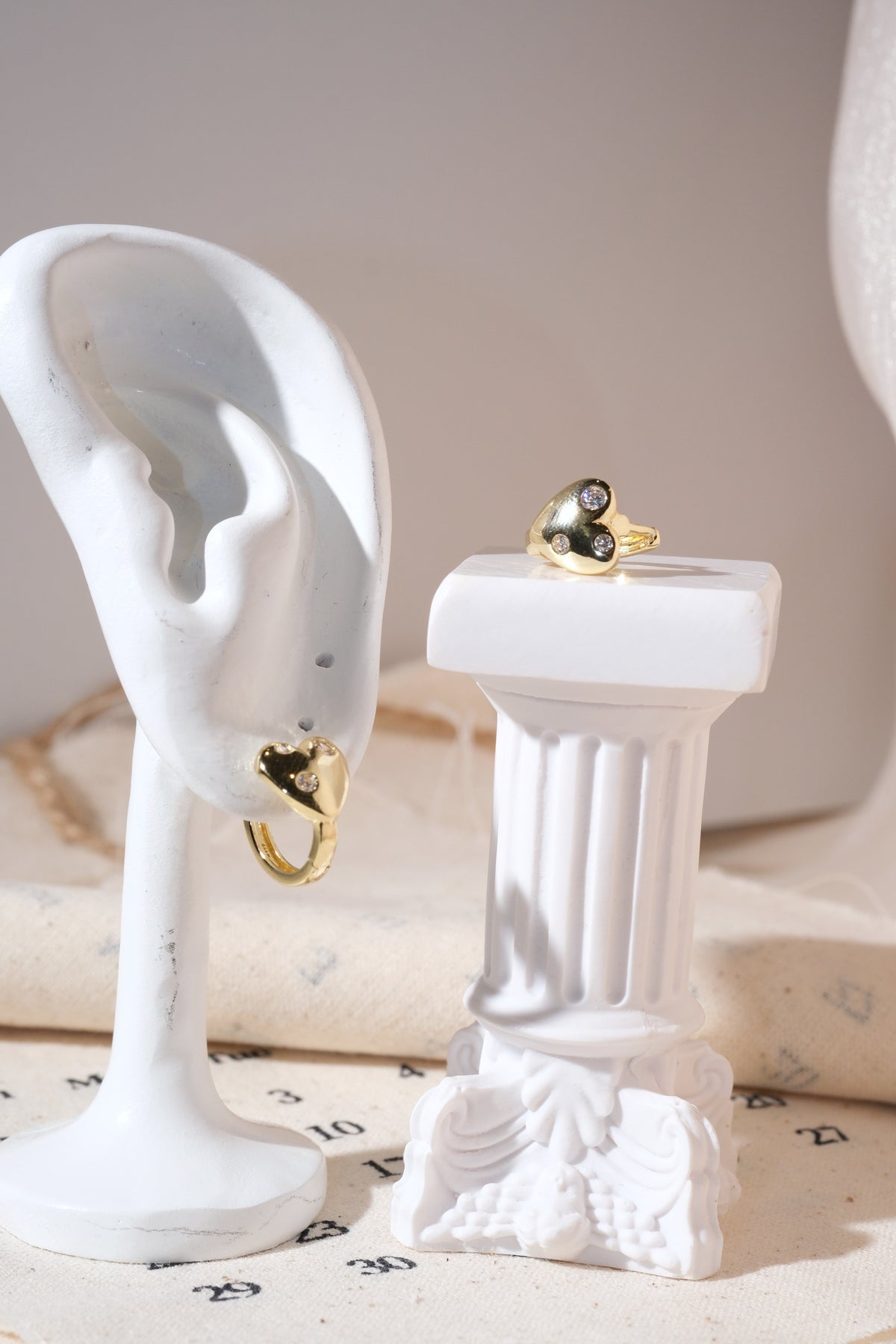 Gold Scattered CZ Heart Huggie Earrings — edited real product photo