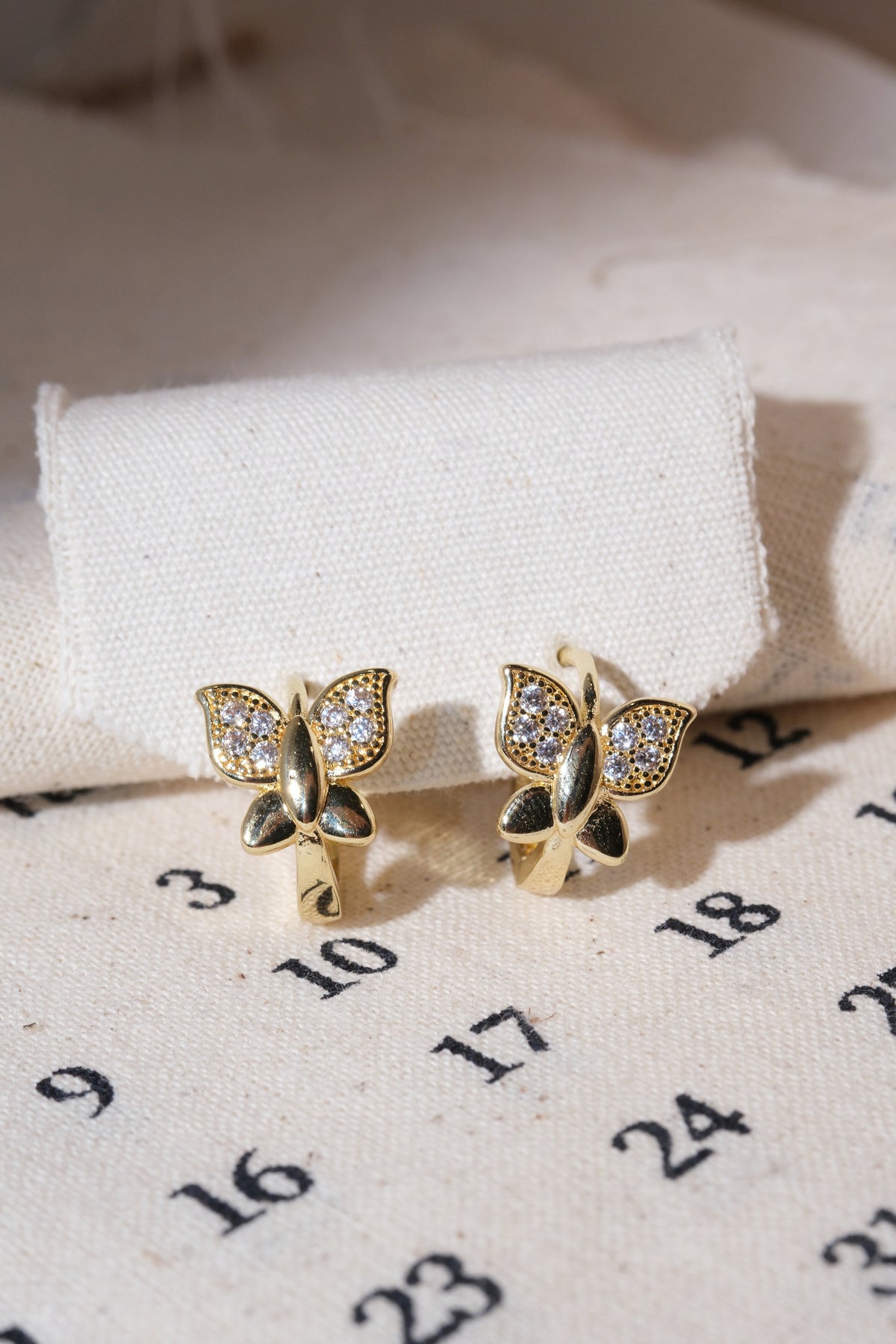 Gold Pave Butterfly Huggie Earrings — edited real product photo