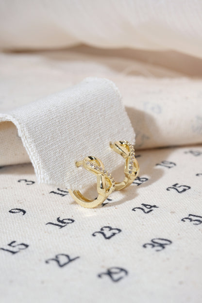 Gold Infinity CZ Huggie Earrings — edited real product photo