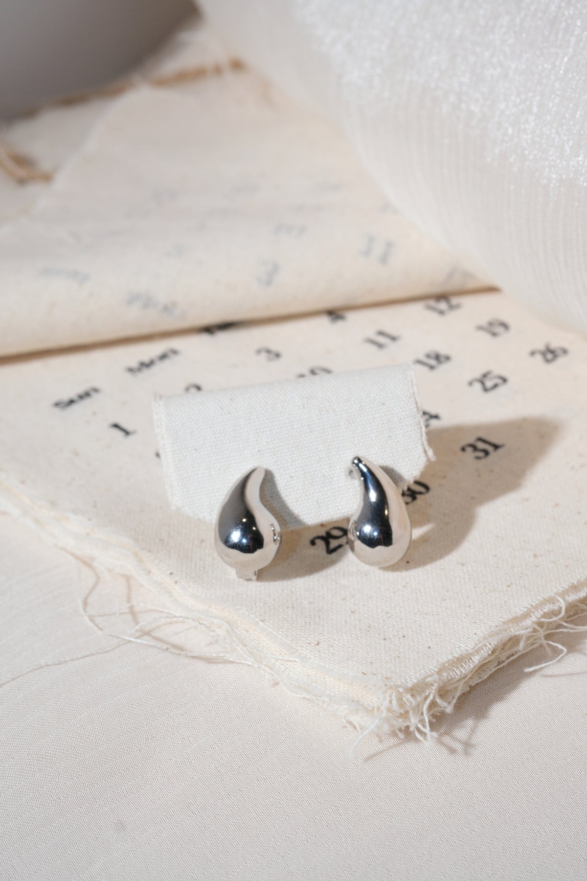 Silver Sculpted Teardrop Earrings — edited real product photo