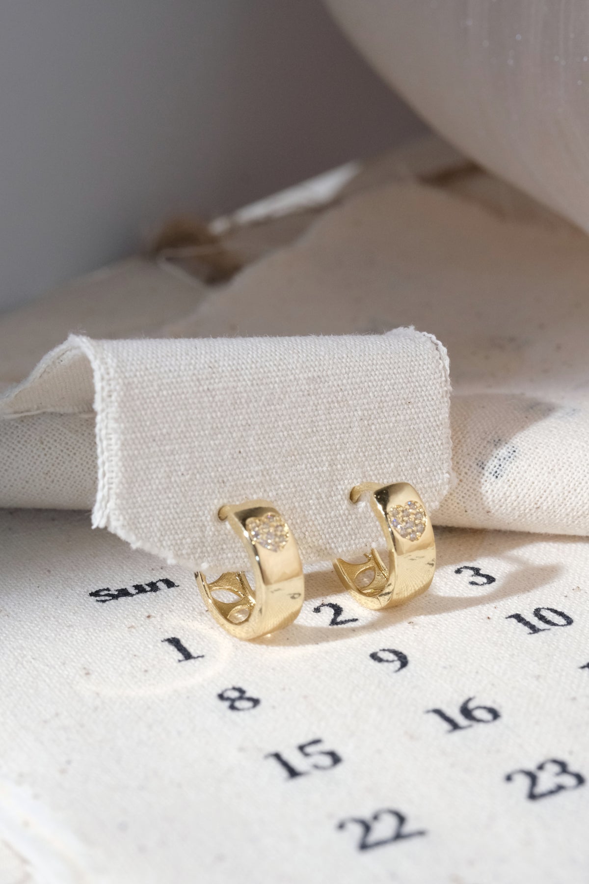 Gold Pave Heart Inlay Huggie Earrings — edited real product photo