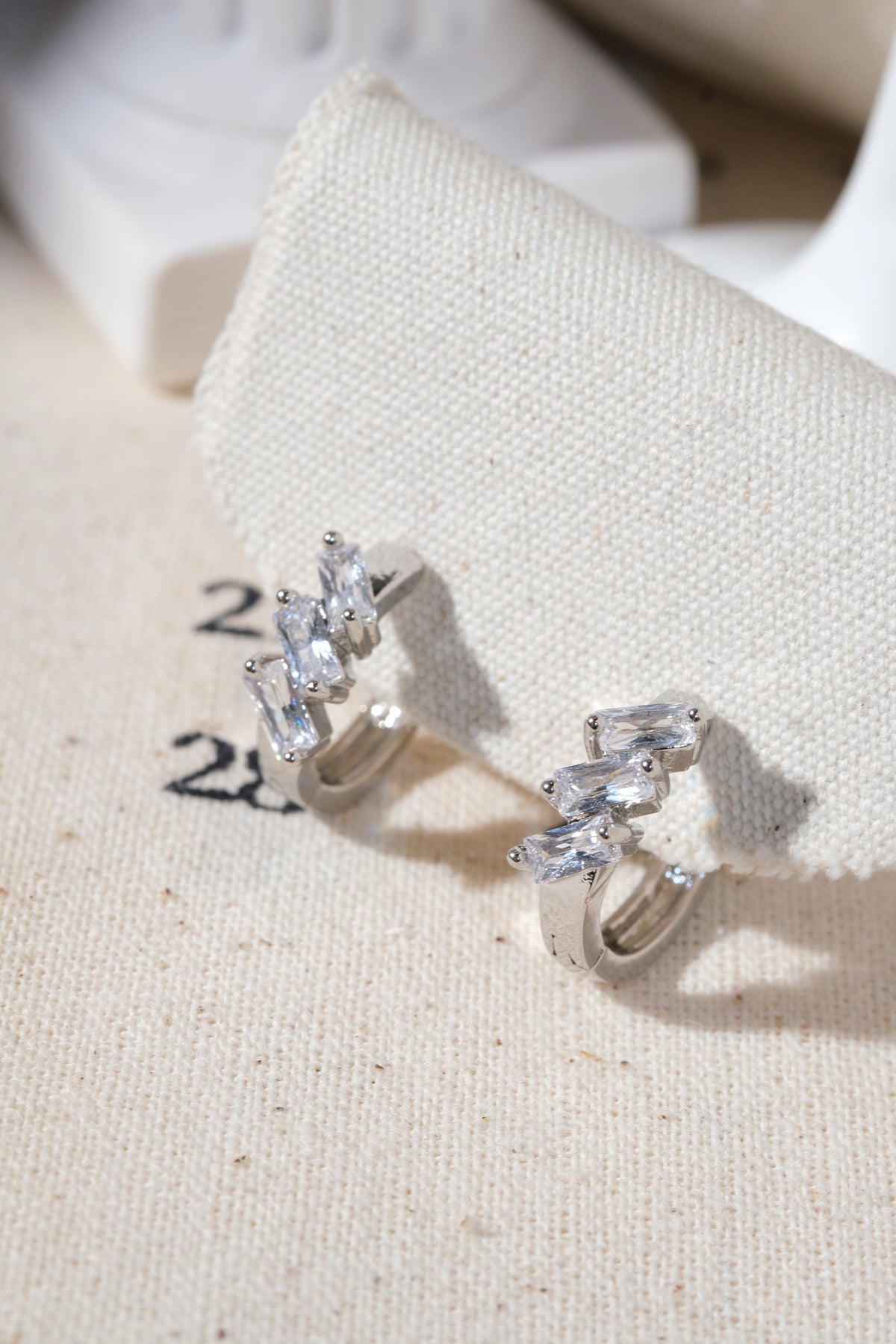 Silver Triple Baguette CZ Huggie Earrings — edited real product photo