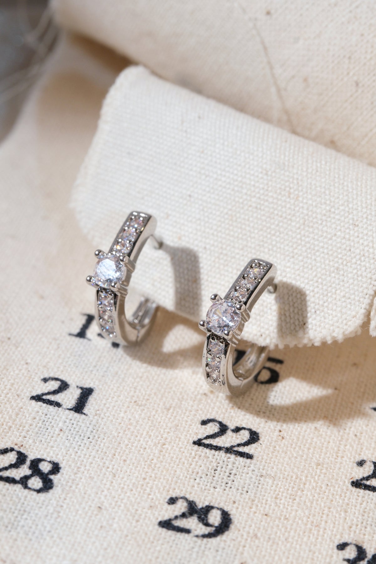 Silver Solitaire CZ Huggie Earrings — edited real product photo