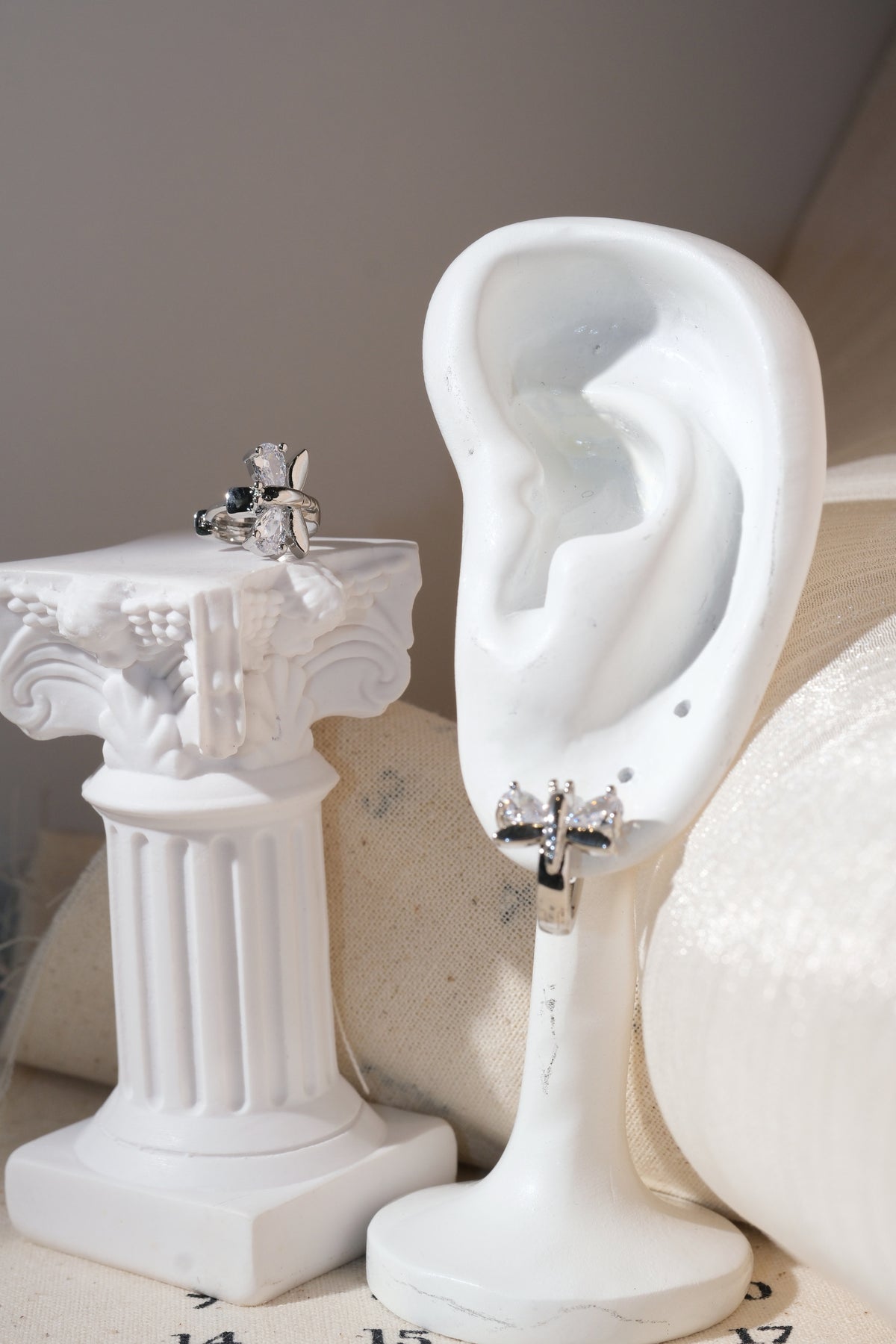 Silver Butterfly Wing Huggie Earrings — edited real product photo