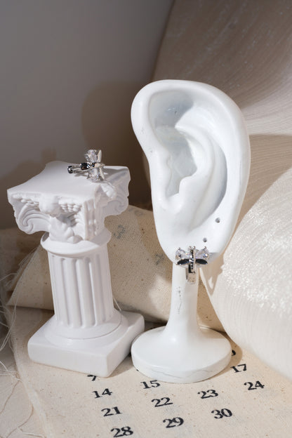 Silver Butterfly Wing Huggie Earrings — edited real product photo