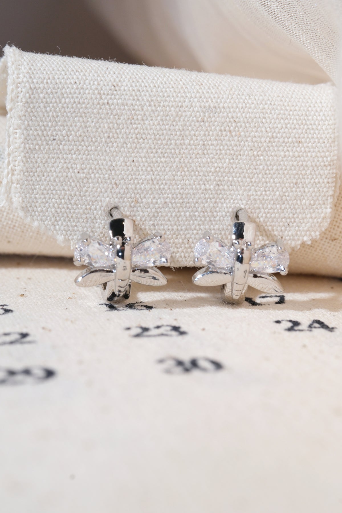 Silver Butterfly Wing Huggie Earrings — edited real product photo