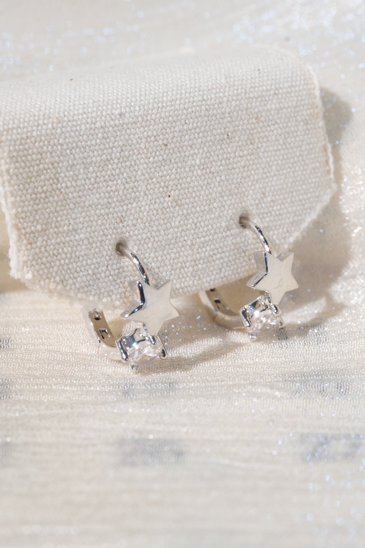 Star Accent CZ Hoops — Silver — edited real product photo
