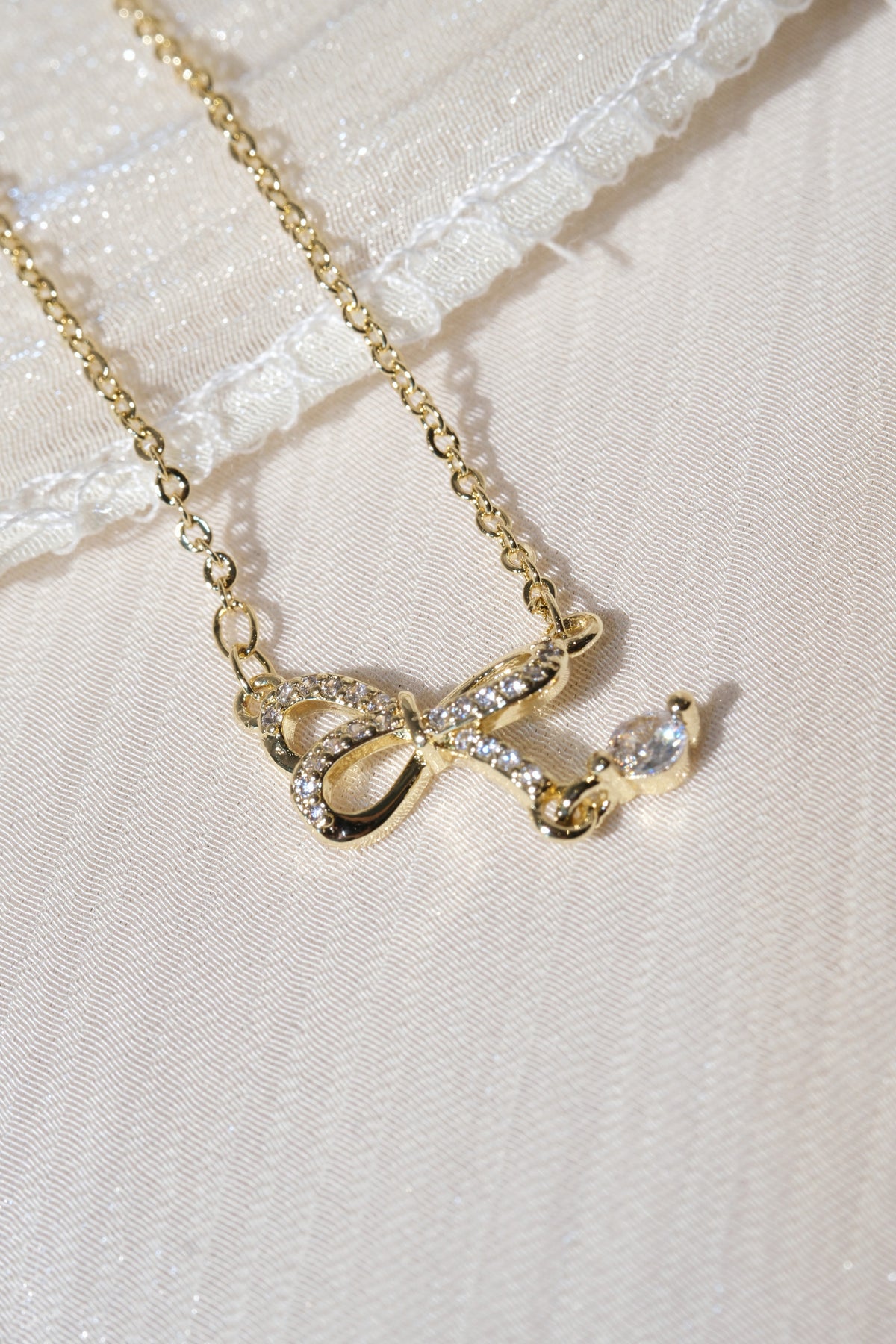 CZ Bow Drop Necklace — Gold — edited real product photo