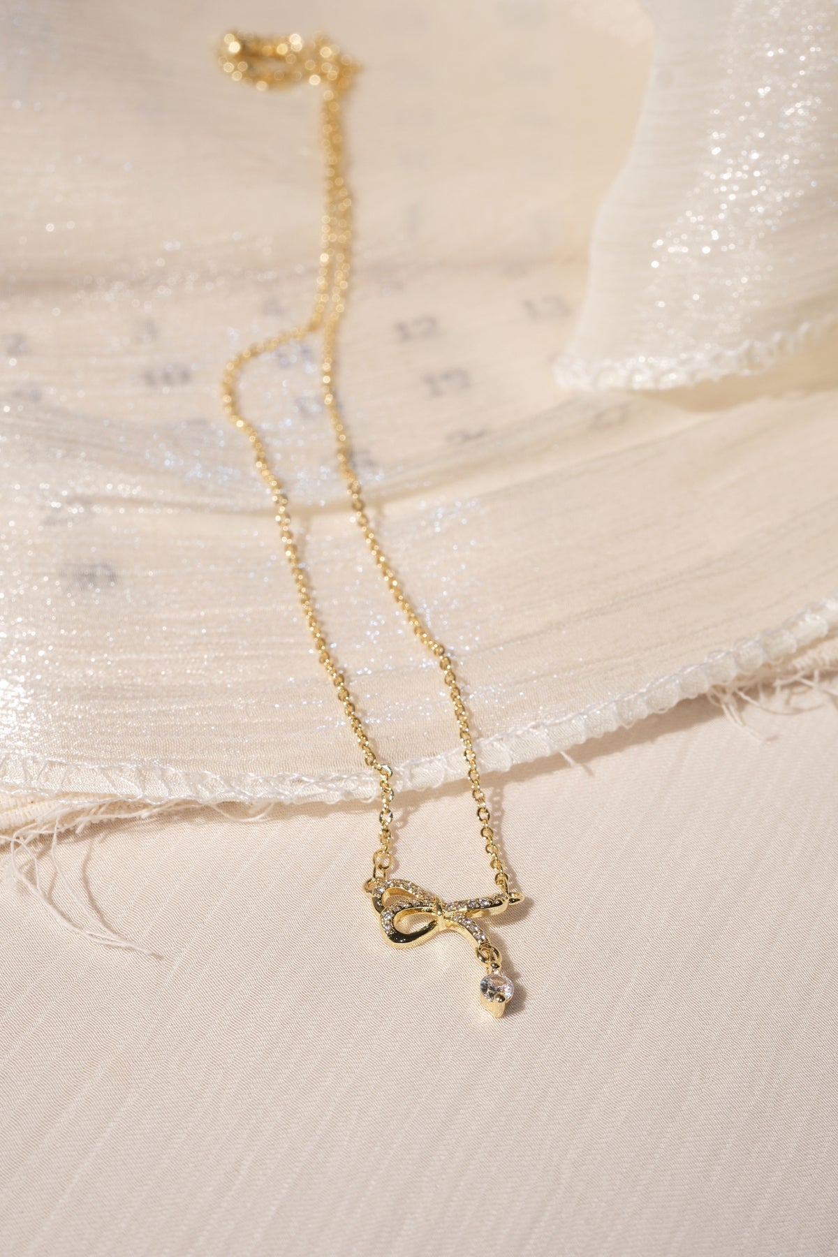 CZ Bow Drop Necklace — Gold — edited real product photo