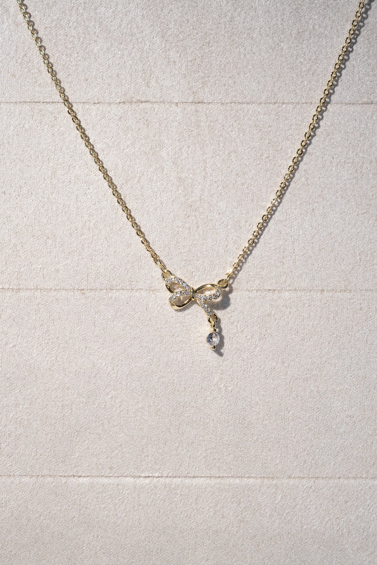CZ Bow Drop Necklace — Gold — edited real product photo