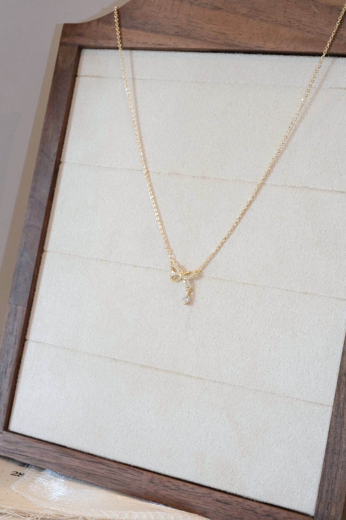 CZ Bow Drop Necklace — Gold — edited real product photo
