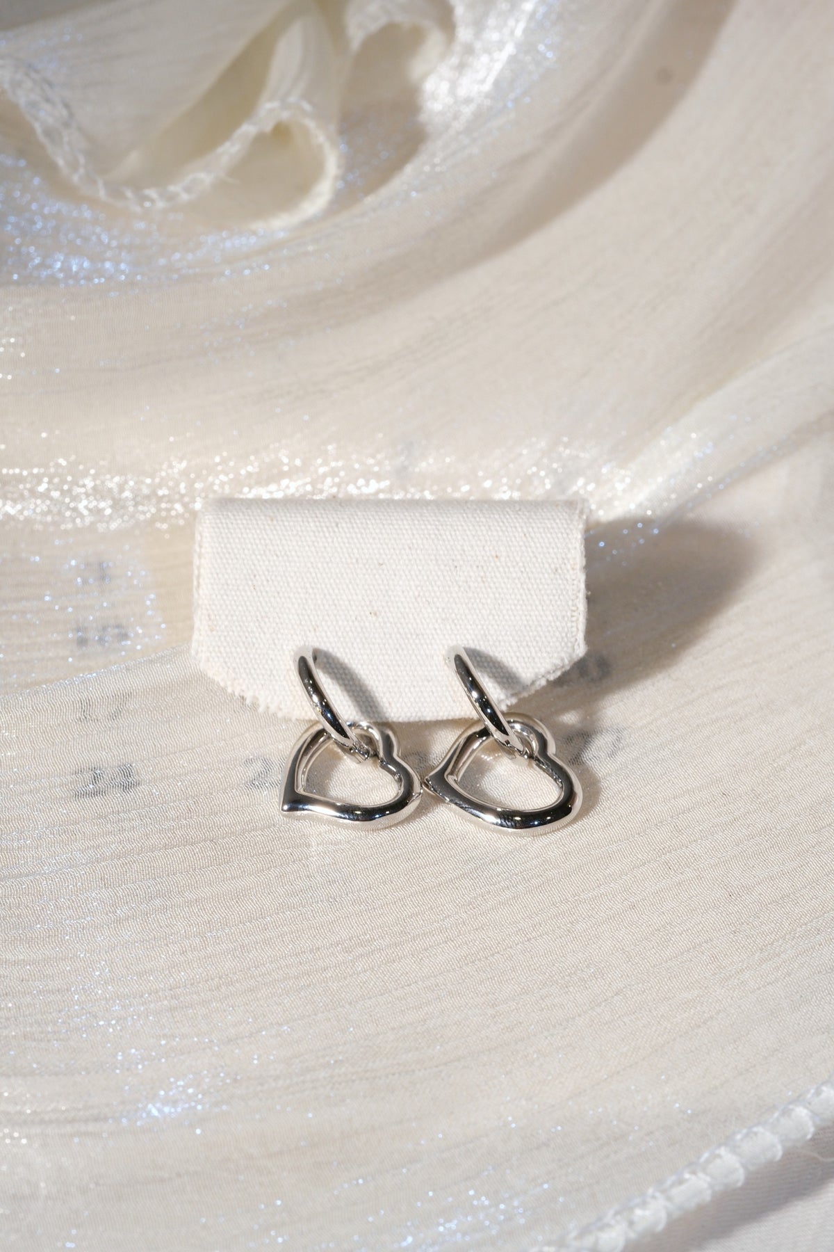 Open Heart Drop Earrings — Silver — edited real product photo