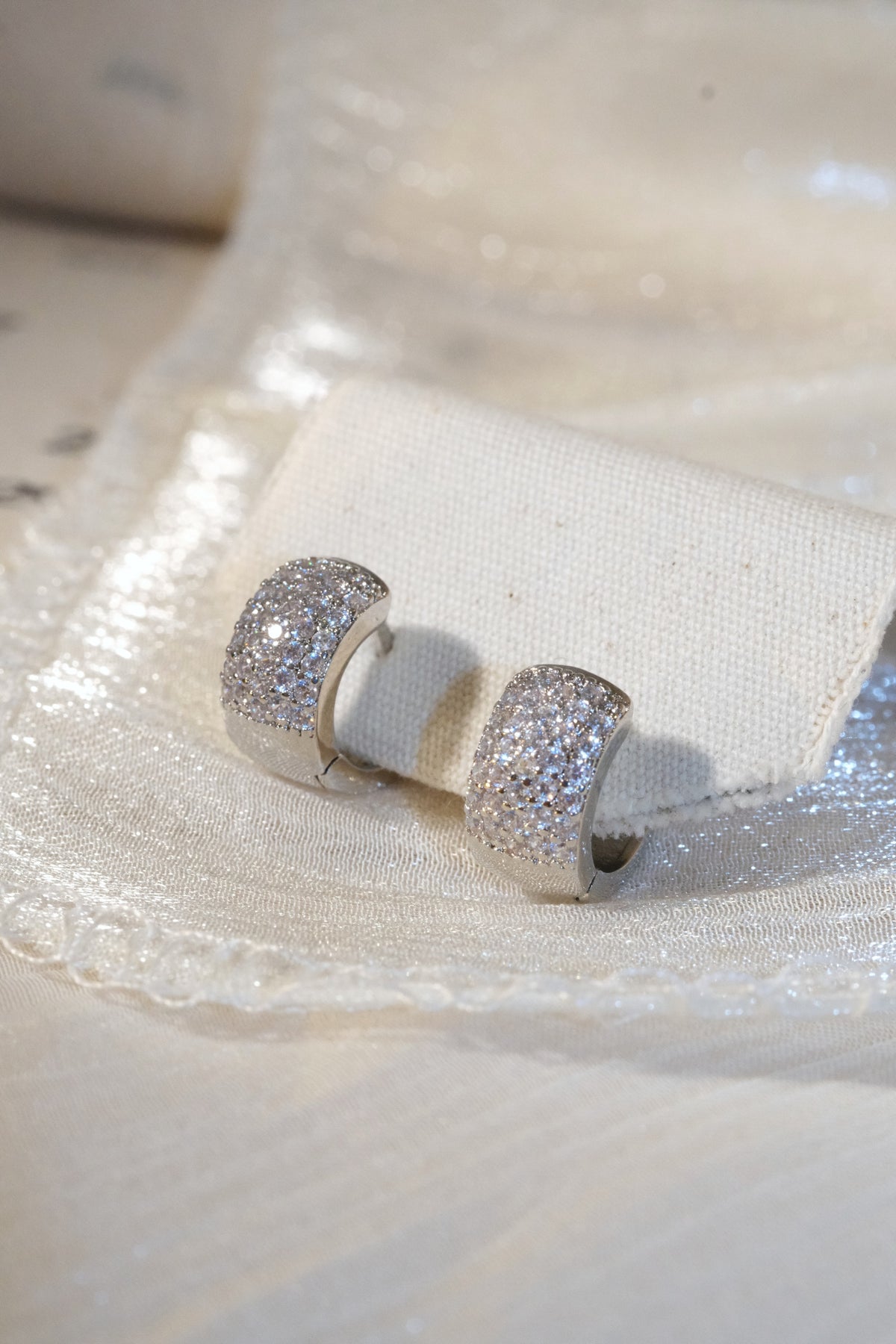 Wide Pavé Huggie Earrings — Silver — edited real product photo