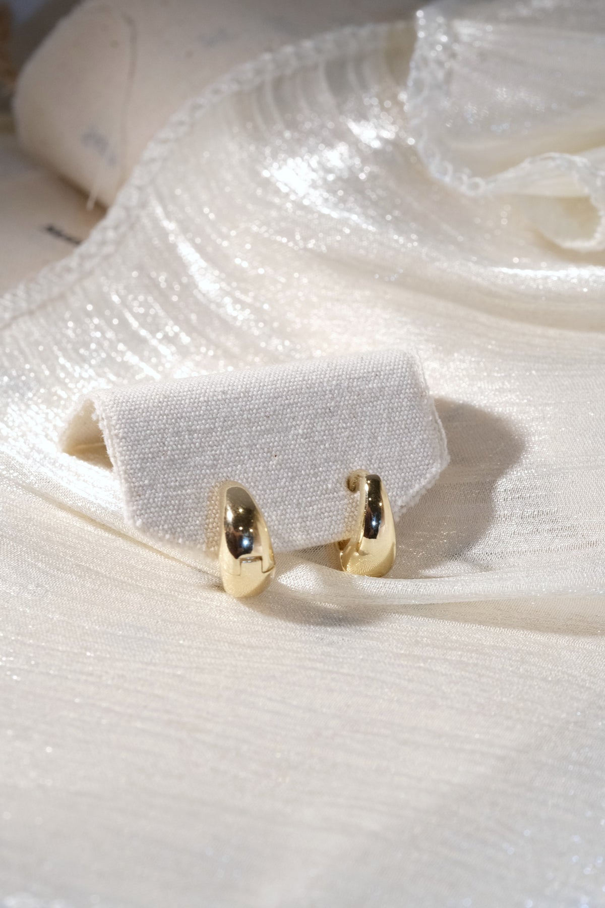 Rounded Huggie Earrings — Gold — edited real product photo