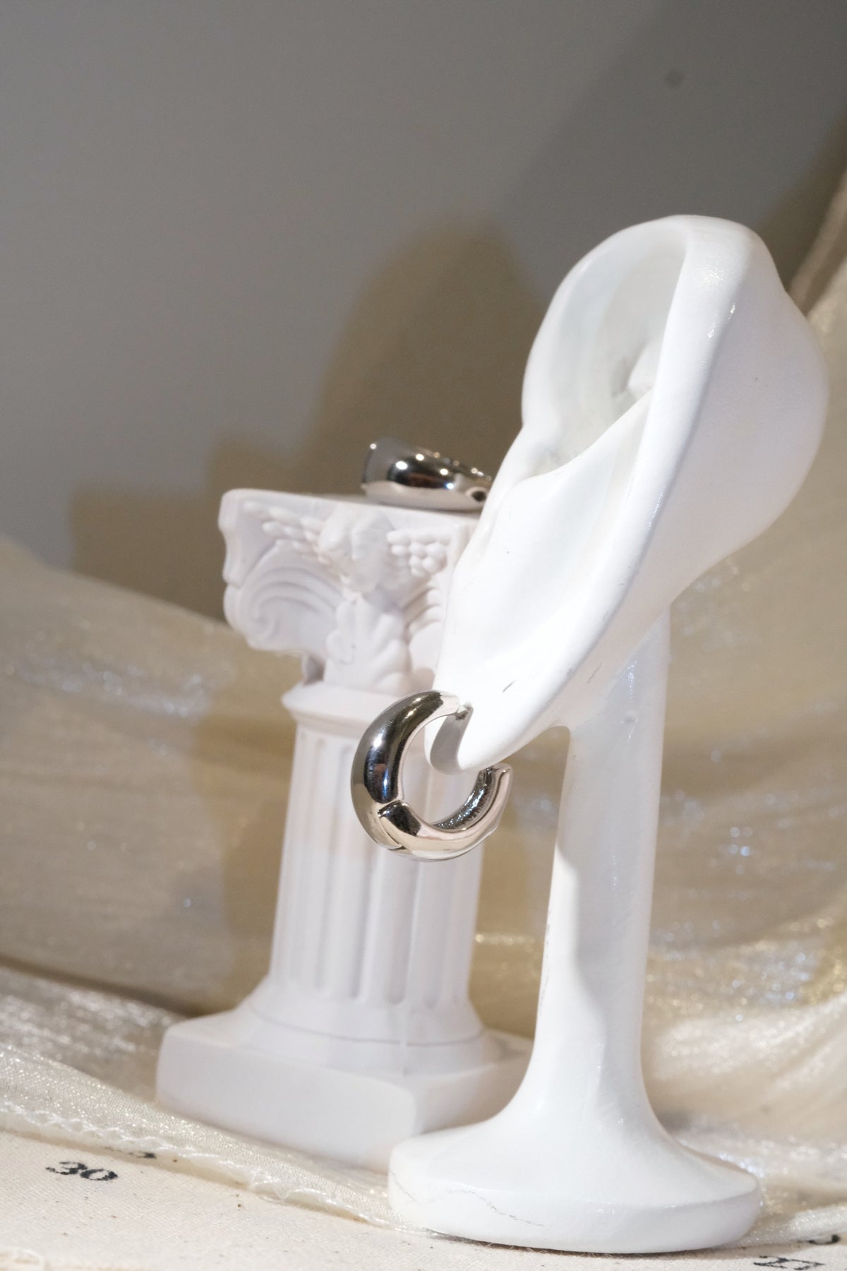 Rounded Huggie Earrings — Silver — edited real product photo