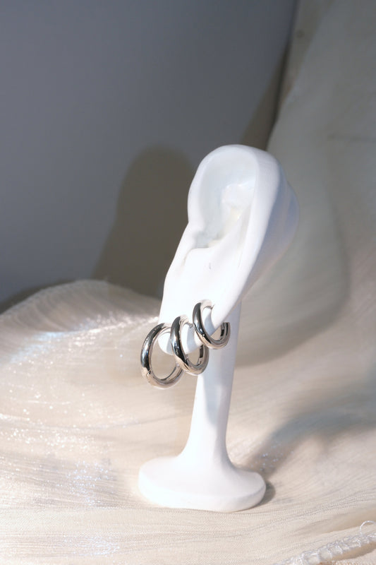 Rounded Polished Hoop Earrings — Silver — edited real-life photo