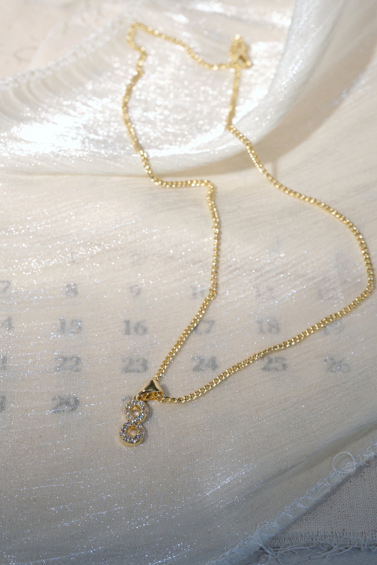 Infinity CZ Pendant — Gold — edited real-life photo