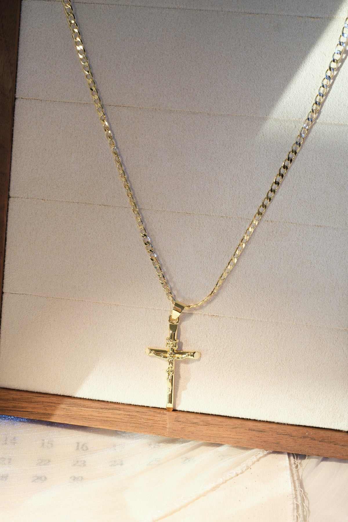 Long Crucifix Pendant — Gold — edited real-life photo