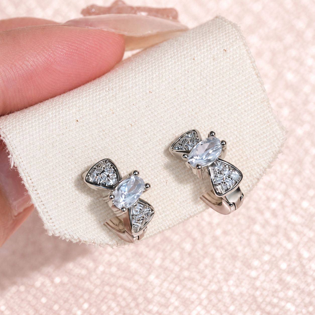 Silver Tone Bow Huggie Hoop Earrings — photographed in real life